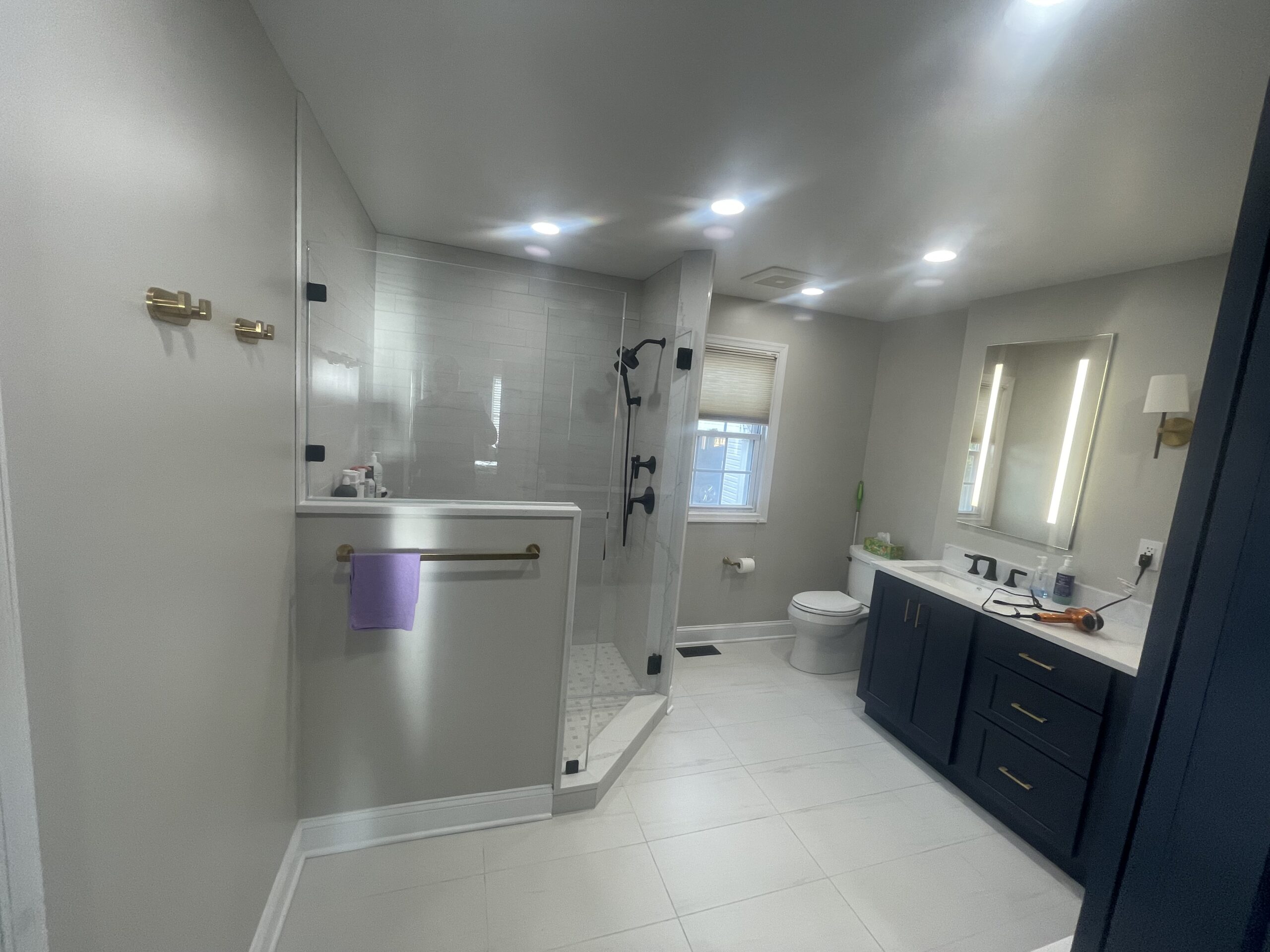 A bathroom with a sink, toilet, and shower