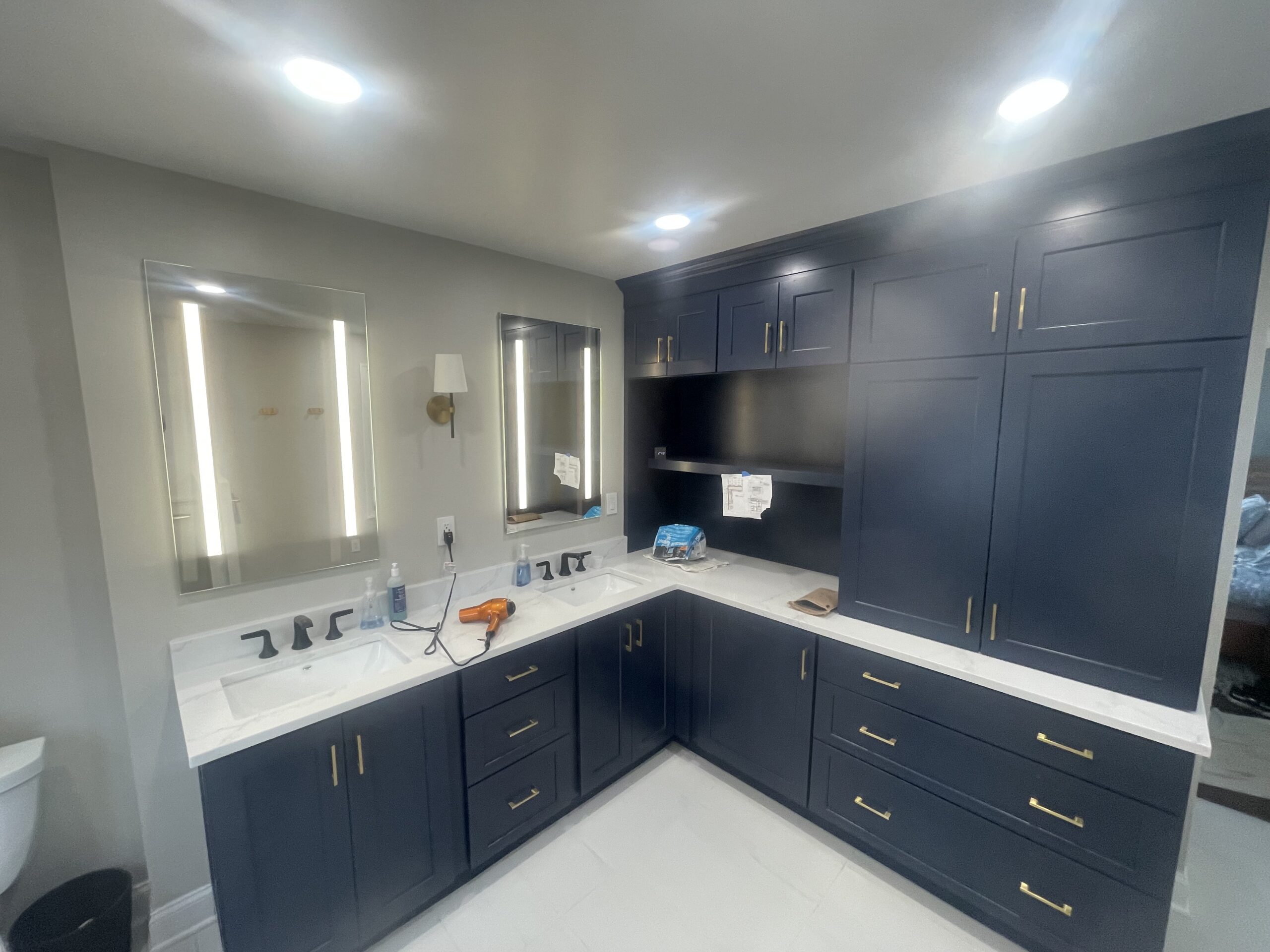 A bathroom with two sinks and two mirrors